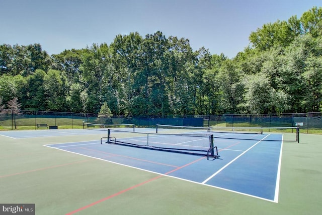 view of tennis court with fence