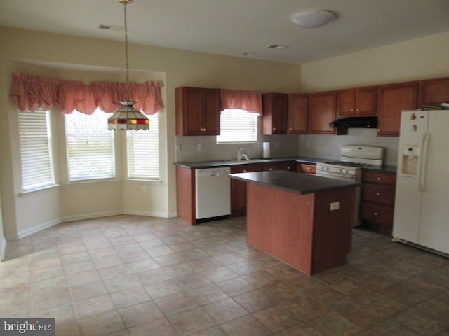 kitchen with white appliances, dark countertops, a kitchen island, under cabinet range hood, and a sink