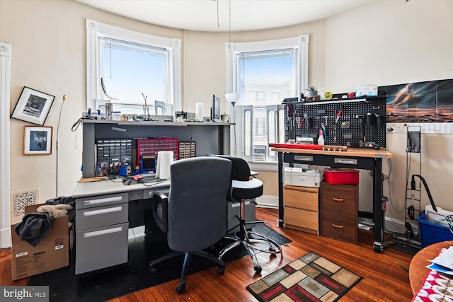 office space with a workshop area and wood finished floors