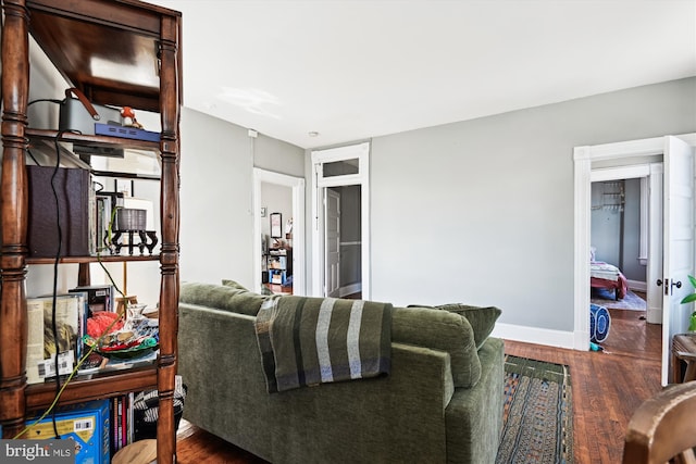 living area with wood finished floors and baseboards