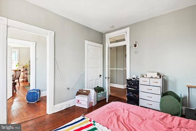 bedroom featuring hardwood / wood-style flooring and baseboards