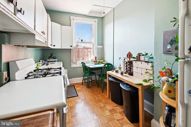 kitchen with baseboards and white cabinetry