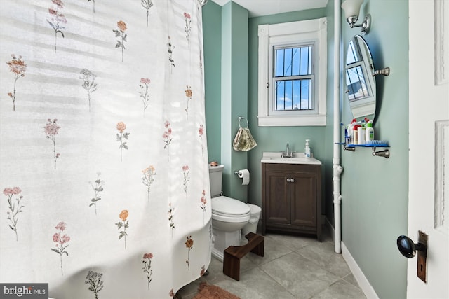 bathroom featuring toilet, tile patterned floors, baseboards, and vanity