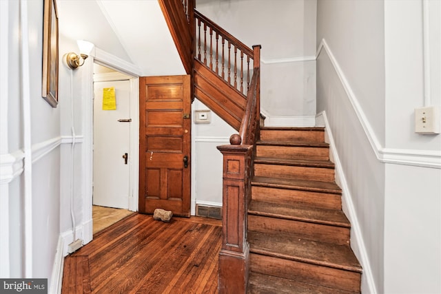 staircase with hardwood / wood-style flooring