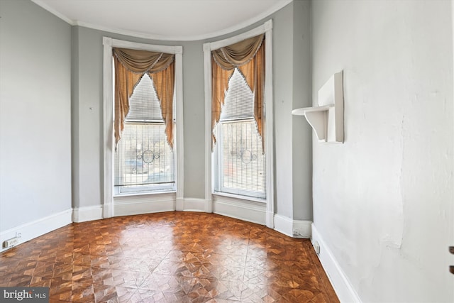 interior space with crown molding and baseboards