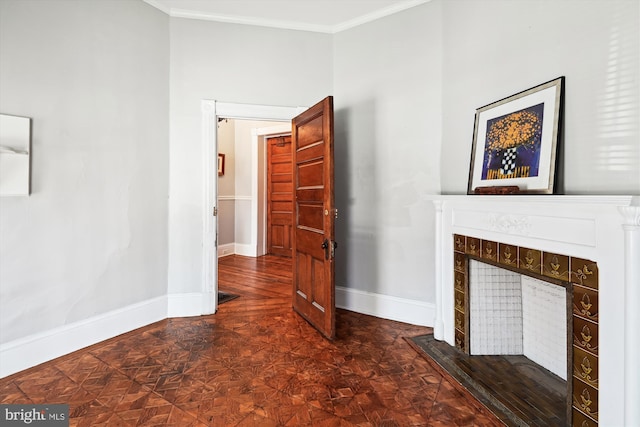 unfurnished living room featuring baseboards, crown molding, and a tile fireplace