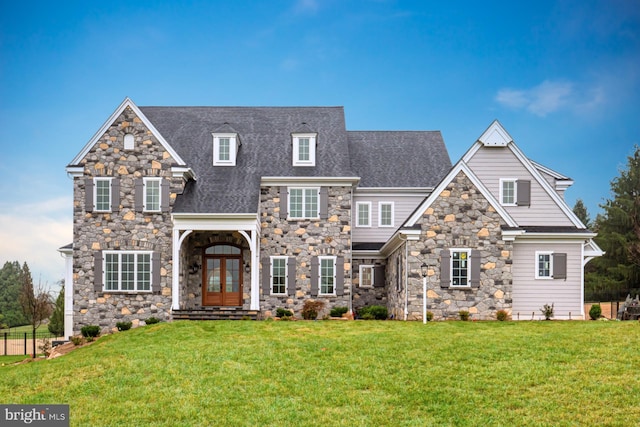 view of front of property featuring a front yard, french doors, and roof with shingles