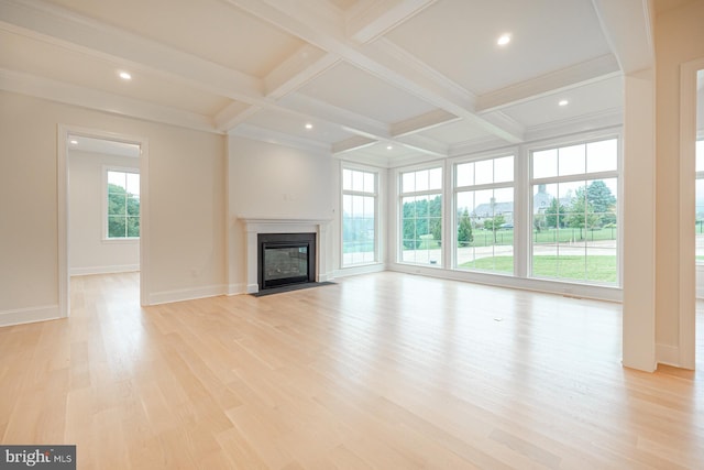 unfurnished living room featuring beam ceiling, a fireplace with flush hearth, light wood-type flooring, coffered ceiling, and baseboards