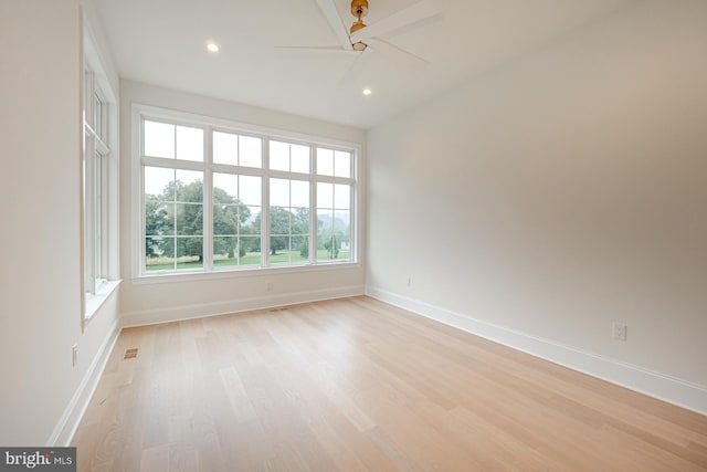 unfurnished room featuring light wood-style floors, baseboards, and recessed lighting