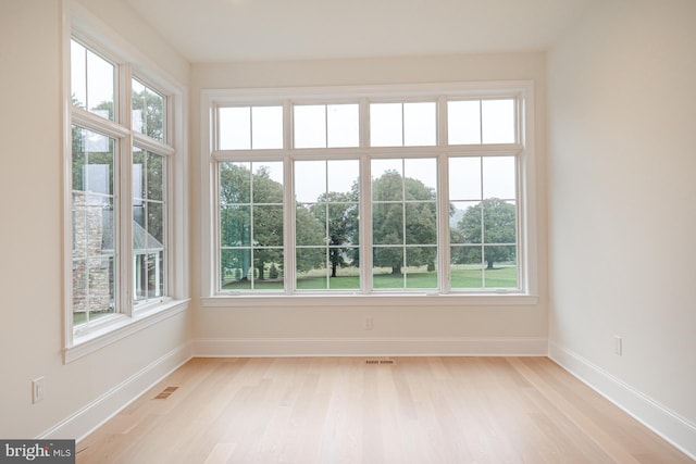 unfurnished sunroom with visible vents