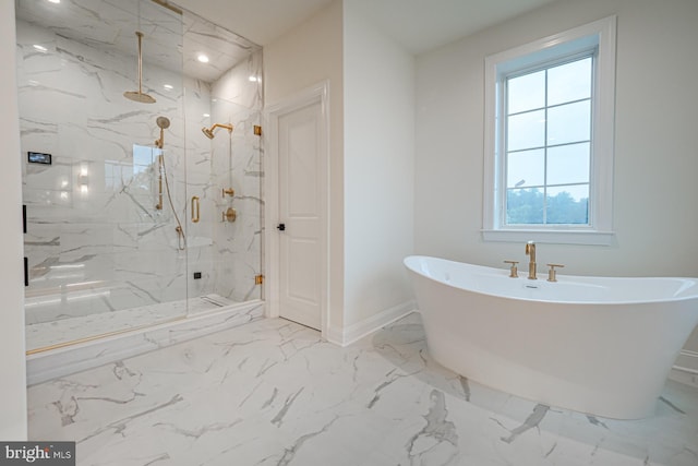 full bath with marble finish floor, baseboards, a freestanding bath, and a marble finish shower