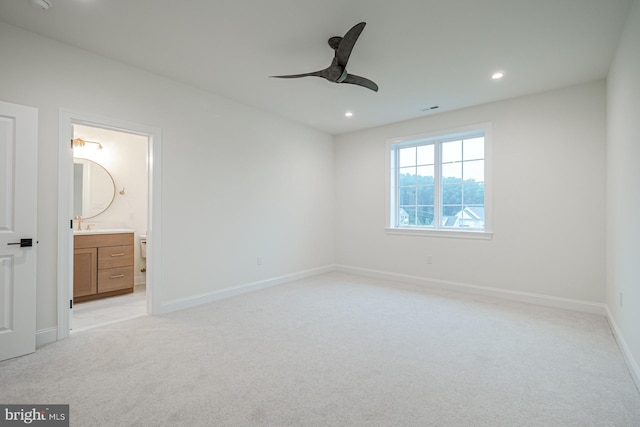 unfurnished bedroom featuring visible vents, baseboards, connected bathroom, light colored carpet, and recessed lighting