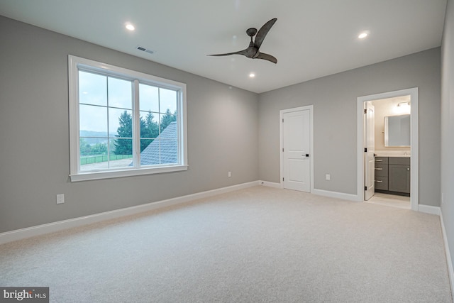 unfurnished bedroom featuring light colored carpet, visible vents, baseboards, and recessed lighting