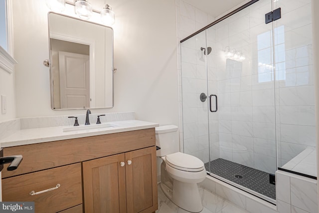 bathroom featuring a stall shower, marble finish floor, vanity, and toilet