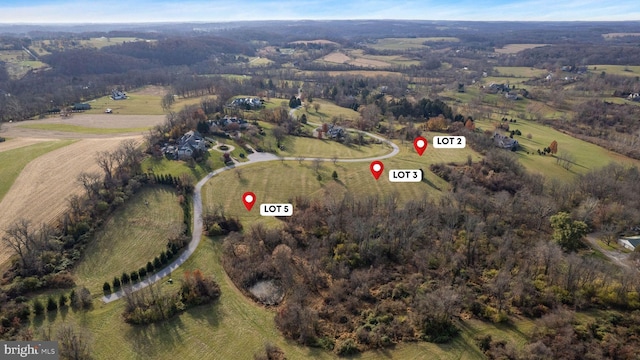 birds eye view of property with a rural view