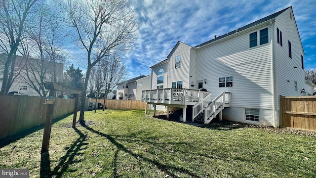 back of house featuring a yard, a wooden deck, stairs, and a fenced backyard