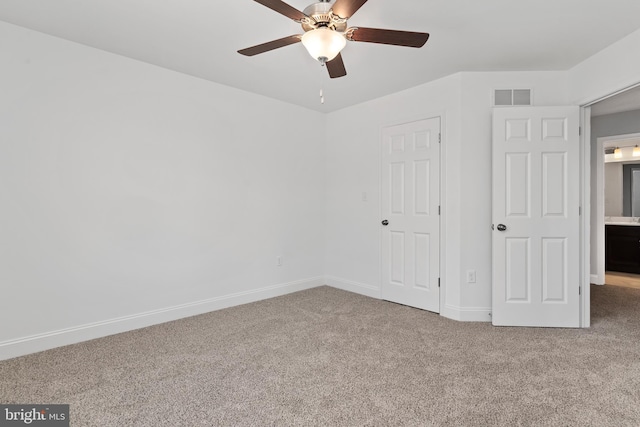 unfurnished bedroom with carpet floors, baseboards, visible vents, and a ceiling fan