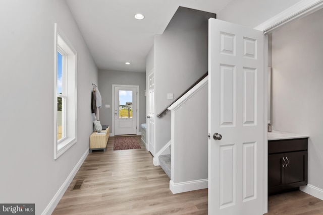 entrance foyer with recessed lighting, visible vents, baseboards, stairs, and light wood-style floors