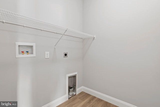 washroom with laundry area, baseboards, hookup for a washing machine, light wood-type flooring, and electric dryer hookup