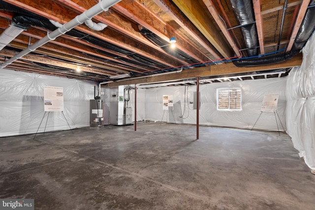 unfinished basement with water heater and heating unit