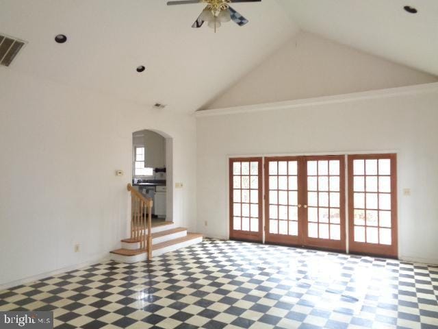 unfurnished living room featuring high vaulted ceiling, arched walkways, visible vents, and a ceiling fan