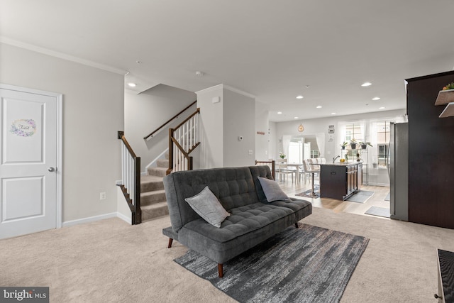 living area featuring light carpet, stairs, crown molding, and recessed lighting