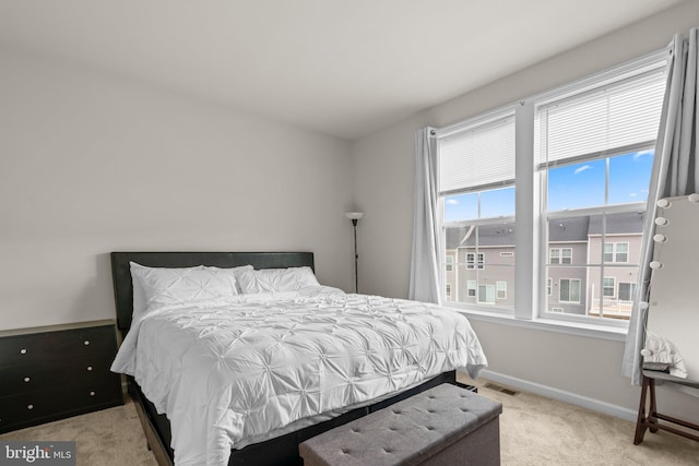 bedroom with carpet floors, baseboards, and visible vents