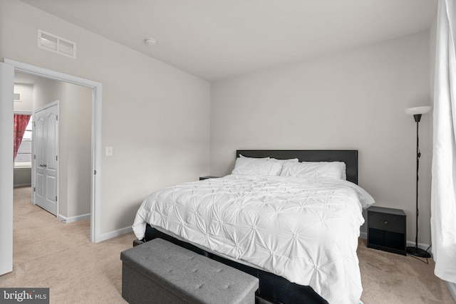 bedroom with baseboards, visible vents, and carpet flooring