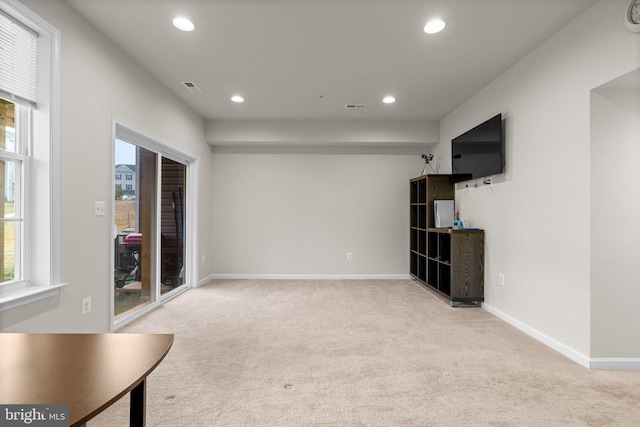 interior space featuring recessed lighting, light colored carpet, and baseboards