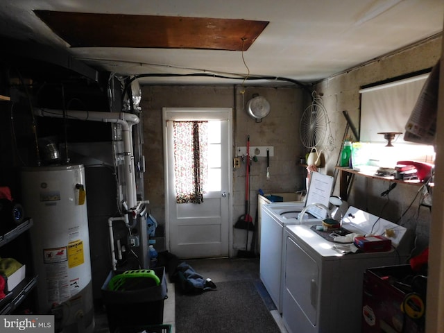 laundry room featuring water heater, laundry area, and independent washer and dryer