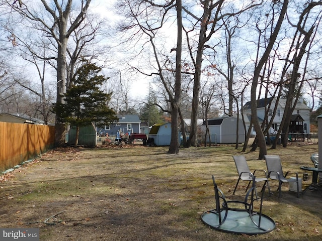 view of yard with a residential view and fence