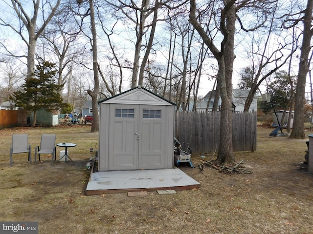 view of shed featuring fence