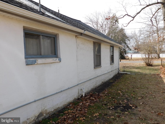 view of side of property with a shingled roof