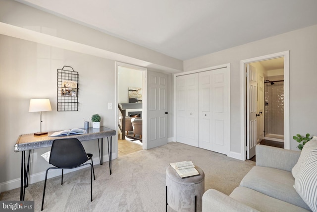 office space with baseboards and light colored carpet