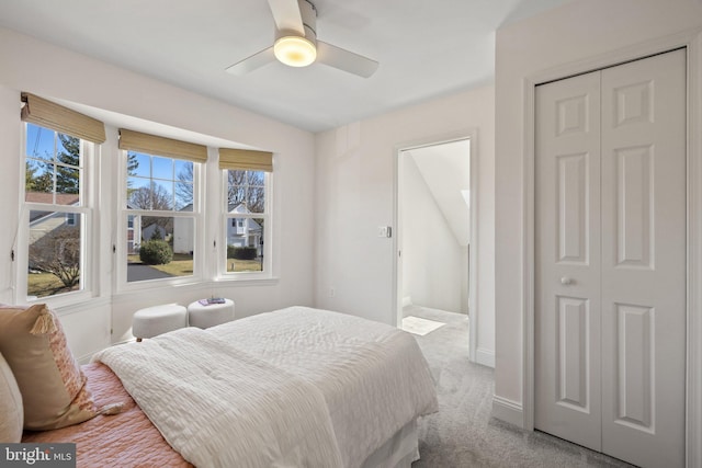 bedroom featuring carpet floors, a closet, ceiling fan, and baseboards