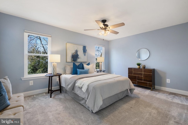 bedroom with ceiling fan, carpet flooring, visible vents, and baseboards