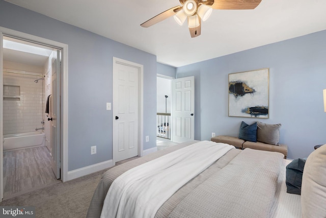 carpeted bedroom featuring ceiling fan, baseboards, and ensuite bathroom