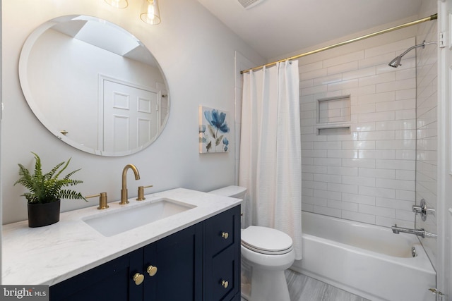 bathroom with toilet, shower / bathtub combination with curtain, and vanity