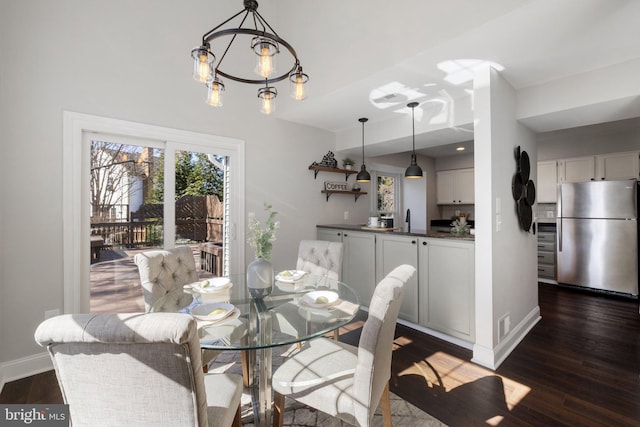 dining room with dark wood-style floors, visible vents, baseboards, and a notable chandelier