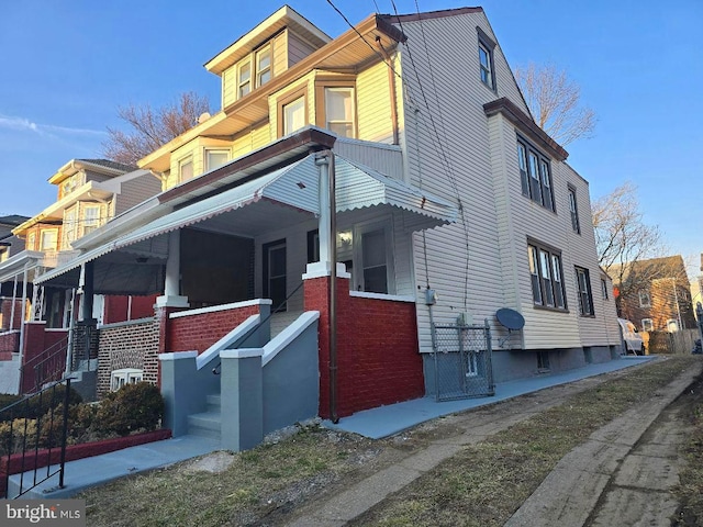 view of home's exterior featuring covered porch and brick siding