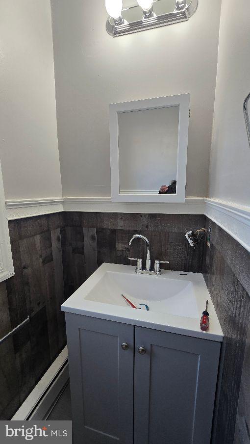 bathroom featuring a wainscoted wall and vanity