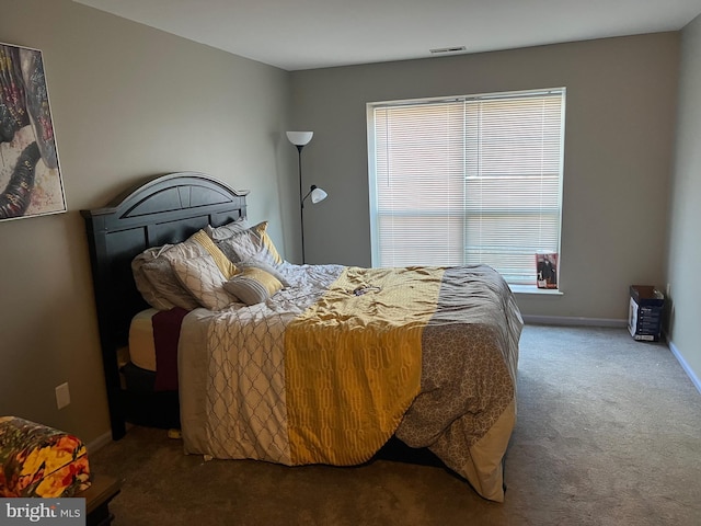 bedroom with baseboards, multiple windows, and visible vents