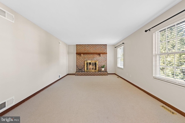 unfurnished living room featuring visible vents, baseboards, and a fireplace