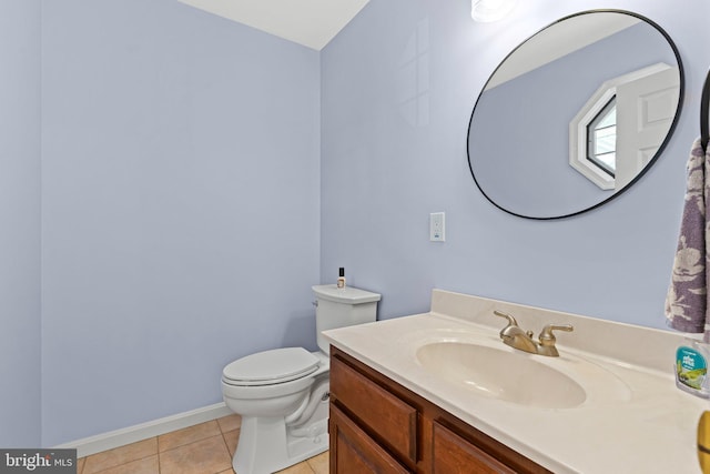 bathroom with tile patterned flooring, toilet, vanity, and baseboards