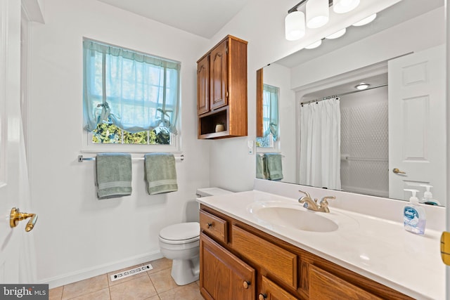 bathroom with vanity, visible vents, baseboards, tile patterned flooring, and toilet