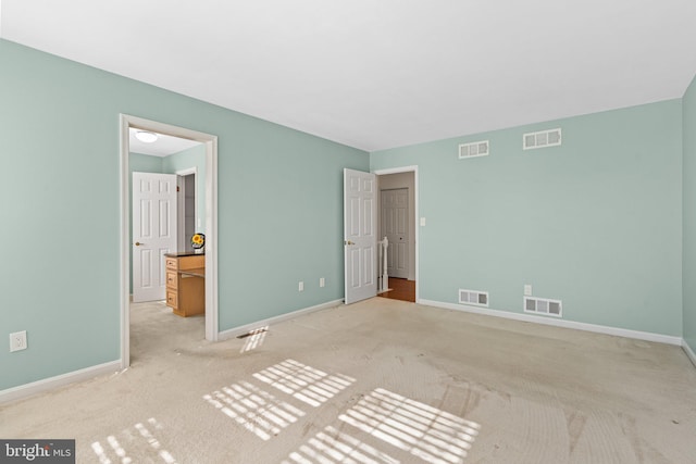 unfurnished bedroom featuring visible vents and baseboards