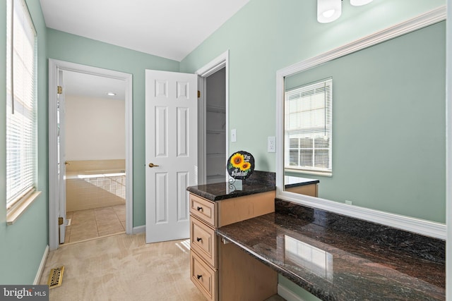 interior space with visible vents, light colored carpet, and baseboards