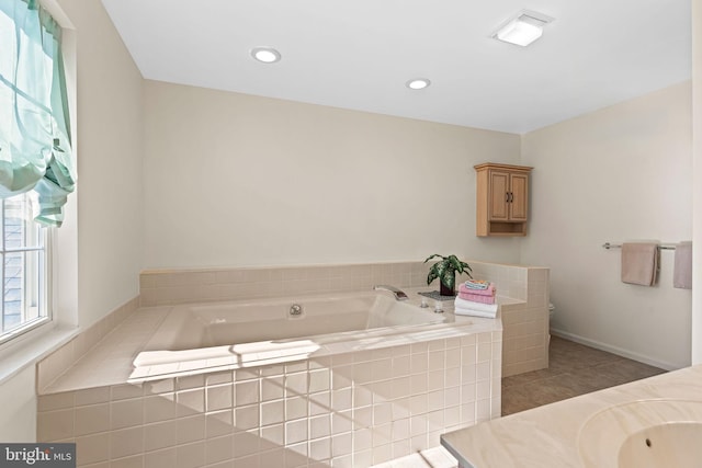 full bath featuring tile patterned flooring, recessed lighting, vanity, and a garden tub