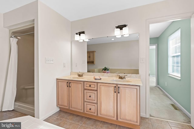 bathroom featuring double vanity, a shower with curtain, and a sink