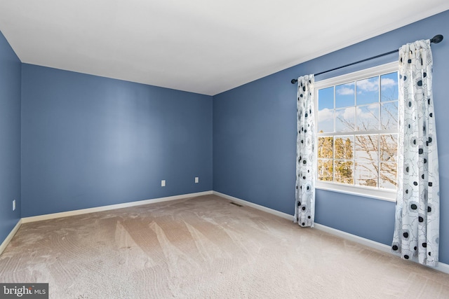 carpeted empty room with baseboards